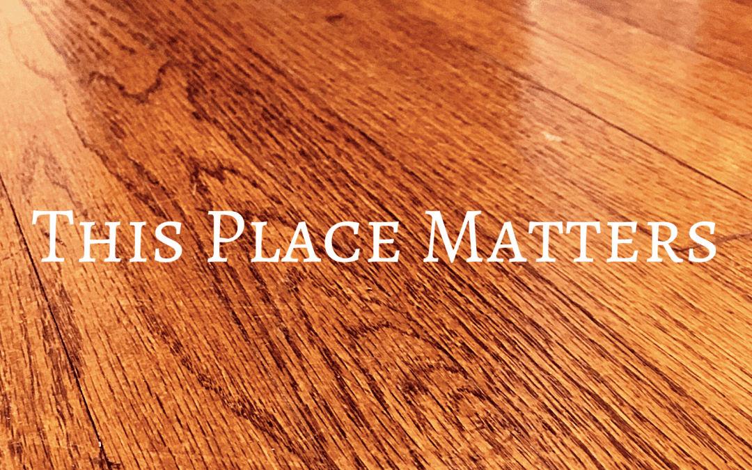 Wood floor with a text overlay that says "this place matters"